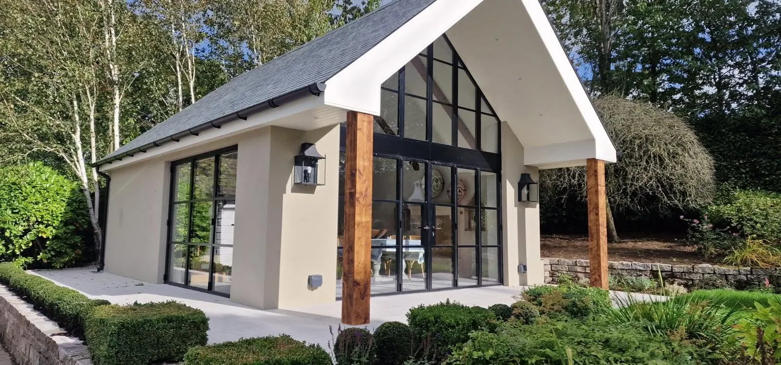 Garden room with a full-height aluminium glazed gable and black French doors fitted by P Black and Son