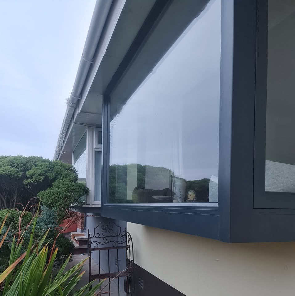 Grey aluminium box bay window on a white rendered house