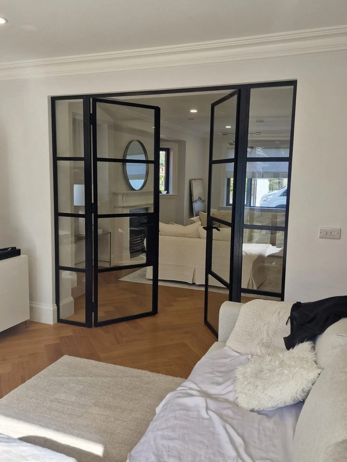 Black steel-look internal double doors dividing a living room