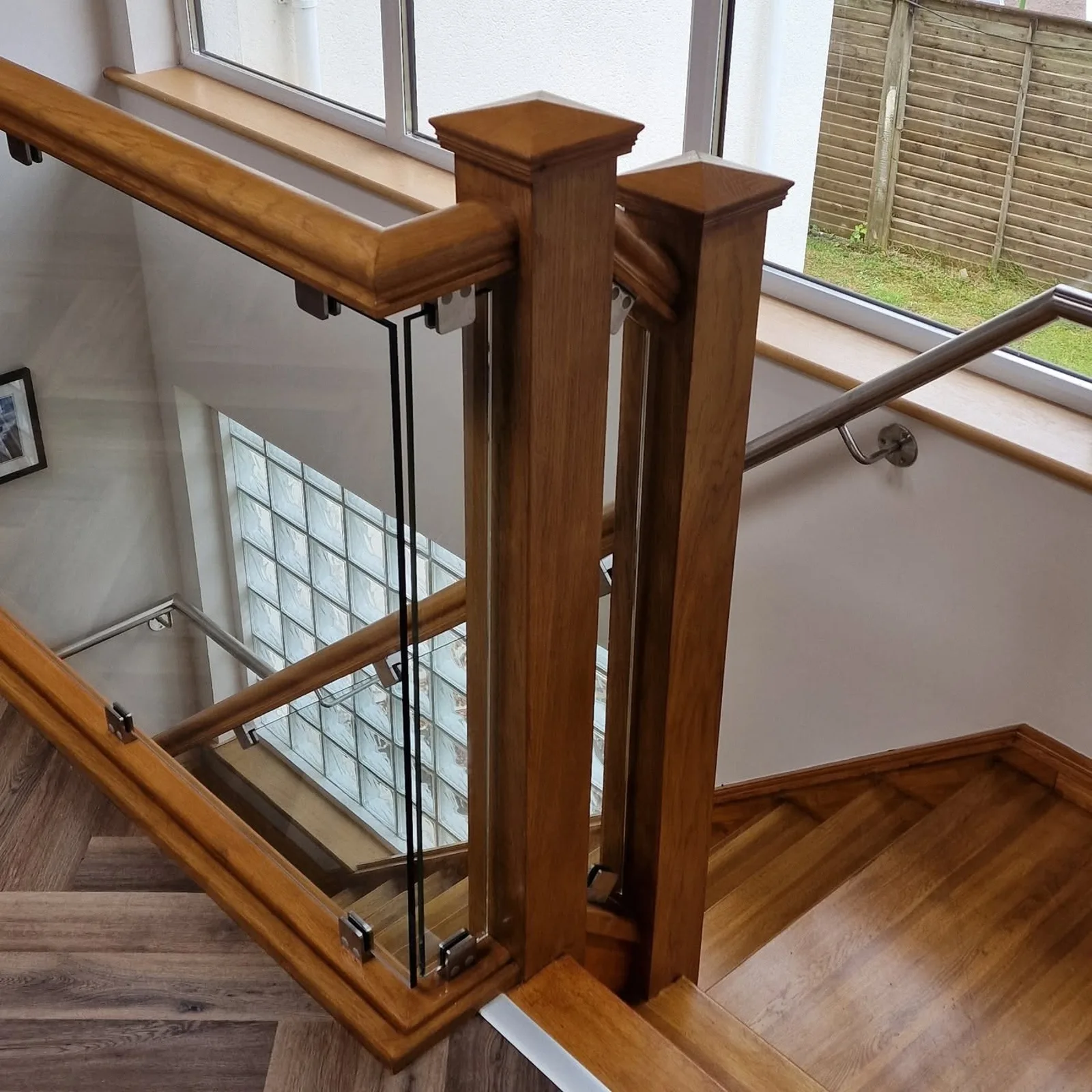 Glass staircase balustrade with oak newel posts and handrail fitted by Coleraine Glass, Northern Ireland