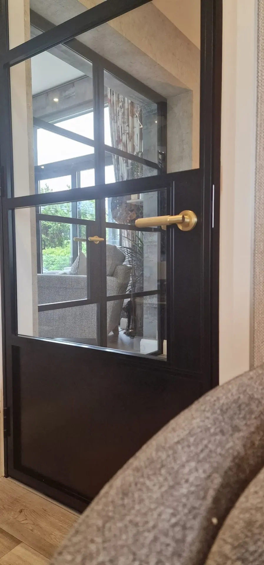 Steel-look internal door with solid lower panel and brass handle