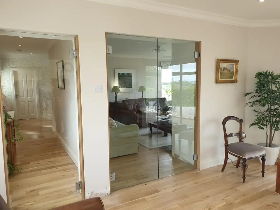 Frameless clear glass internal doors into a living room