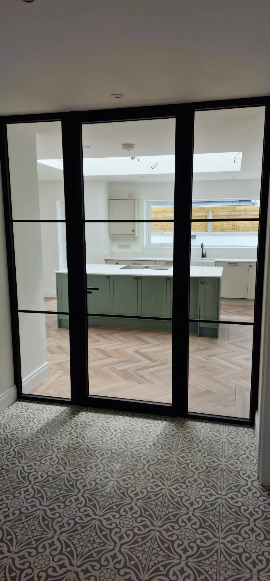 Steel-look glazed internal screen and door between hallway and kitchen