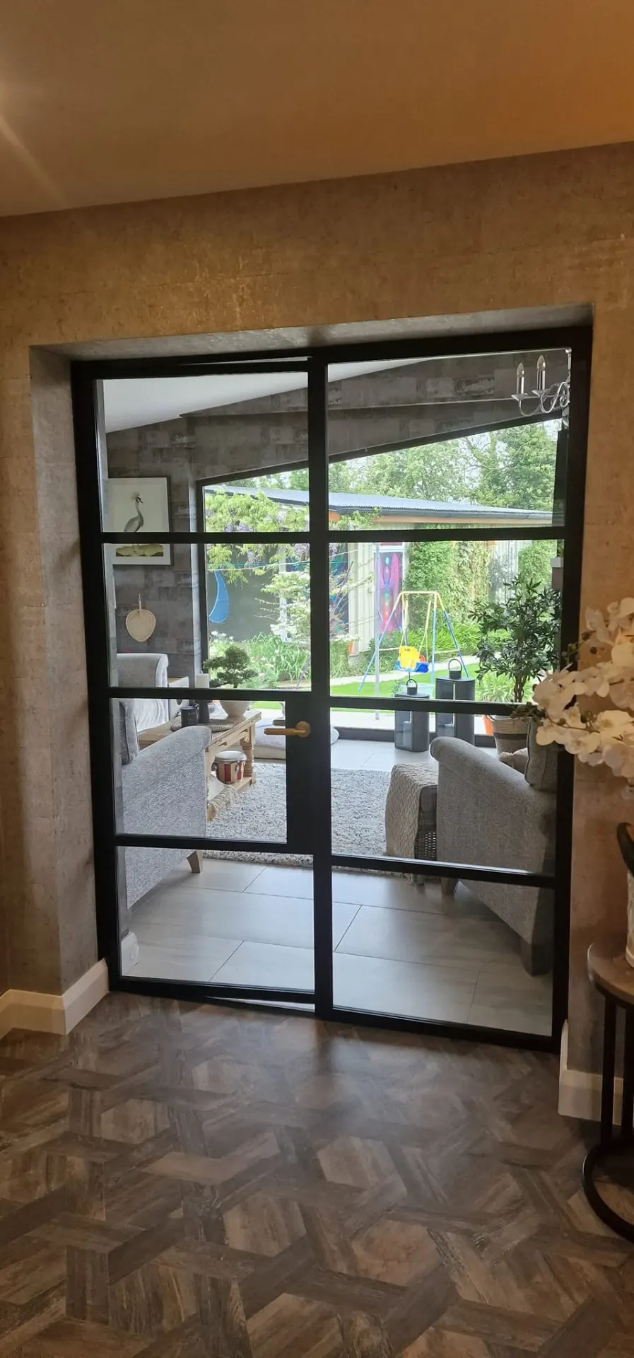 Black glazed aluminium French doors leading into a garden room, Northern Ireland