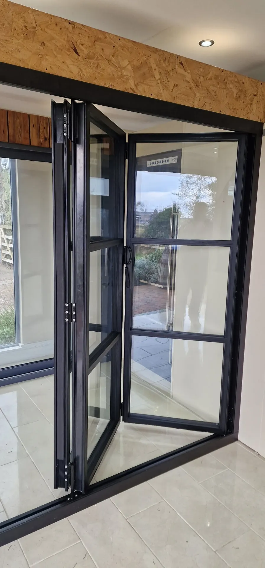 Steel-look aluminium bi-fold door on display in the P Black and Son showroom, Coleraine