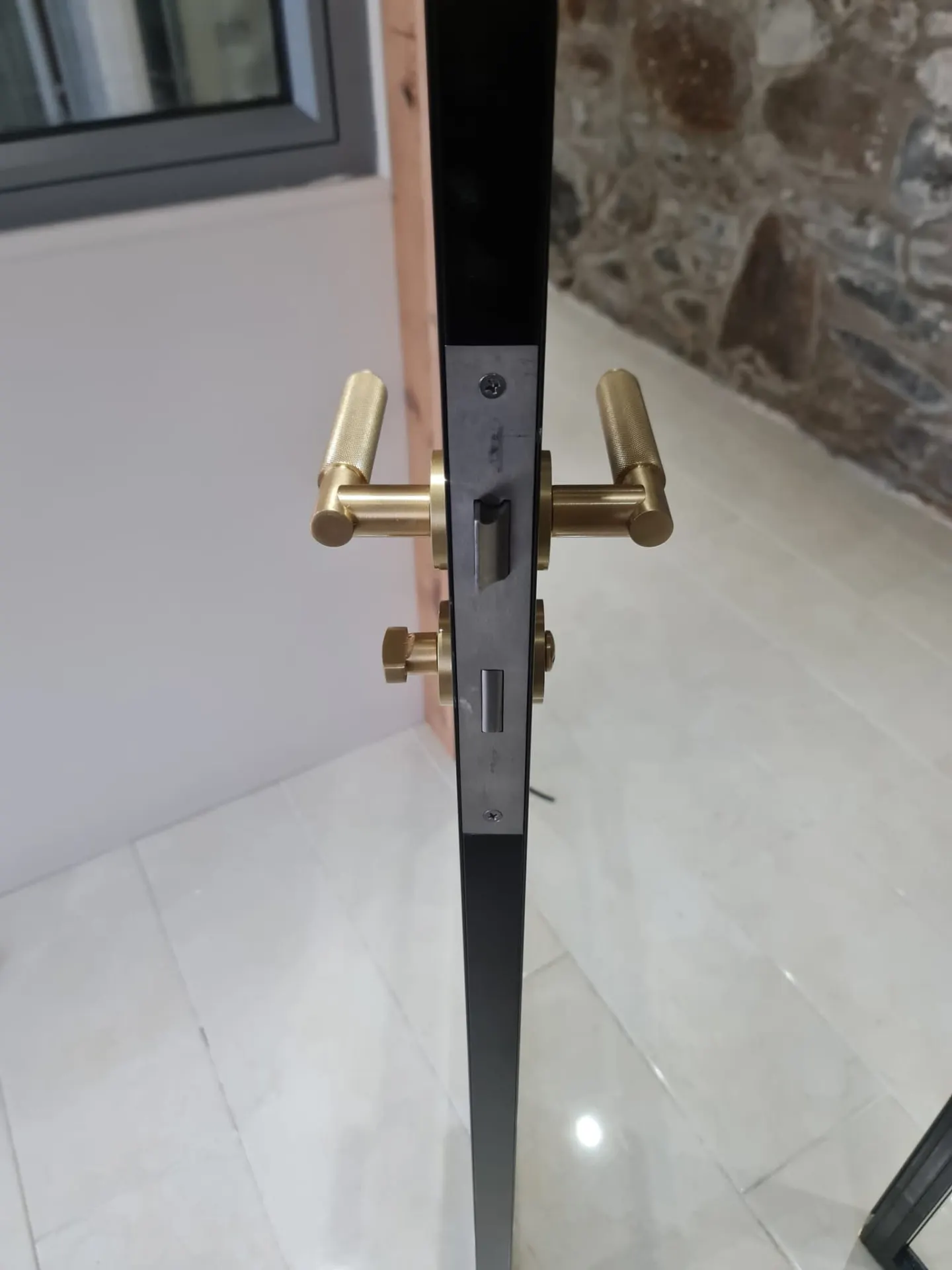 Brass lever handle on a steel-look internal door