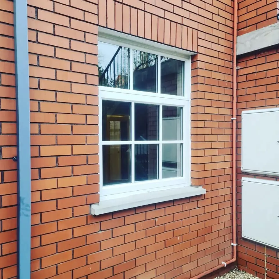 White Georgian window in a red brick wall