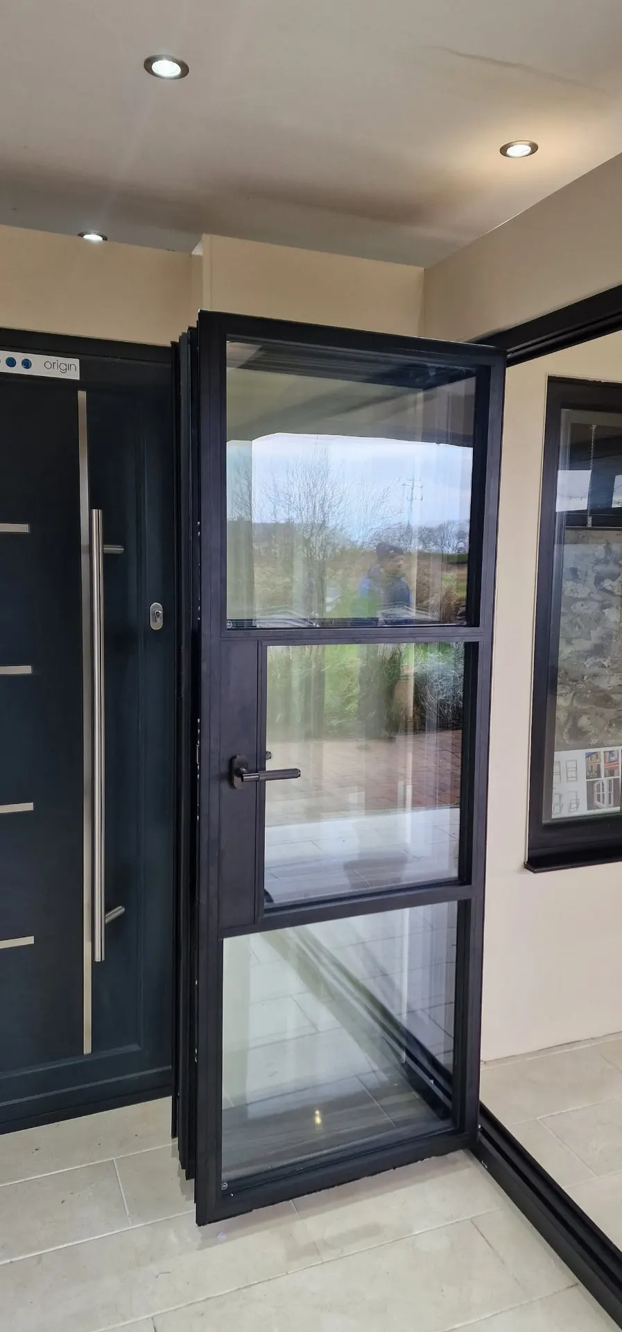 Black steel-look bi-fold door with Georgian bars in the showroom
