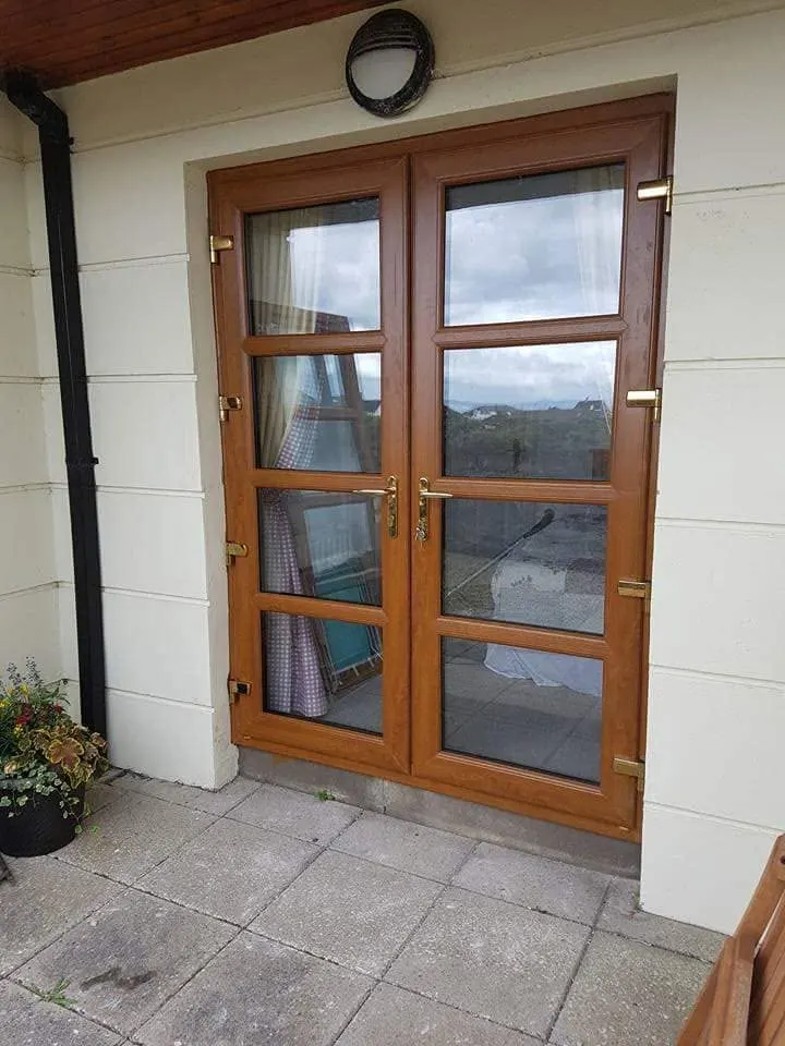 Oak-effect French doors on a rendered house