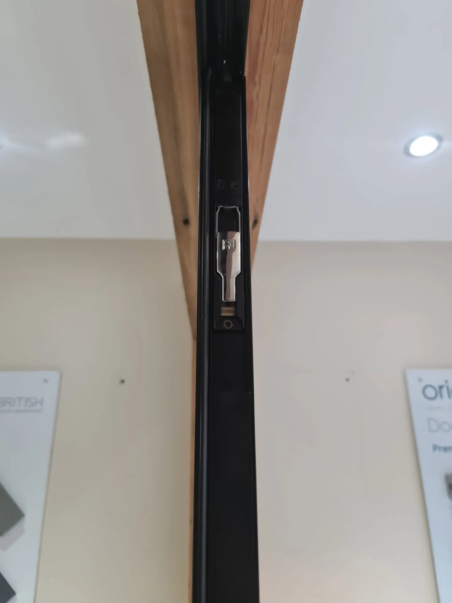 Multi-point lock detail on a black aluminium door in the Coleraine showroom